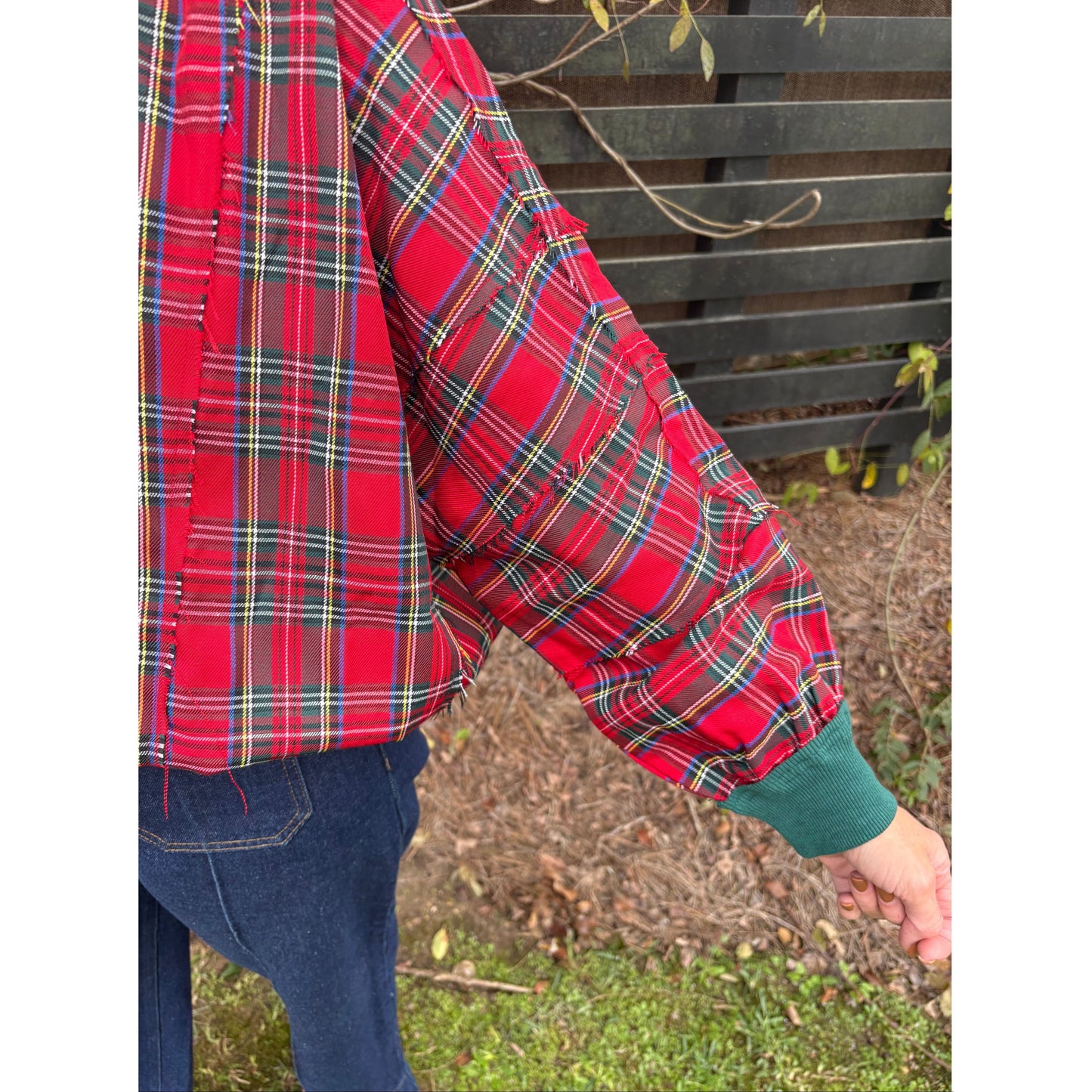 Red plaid pants being worn outdoors with a blurred background
