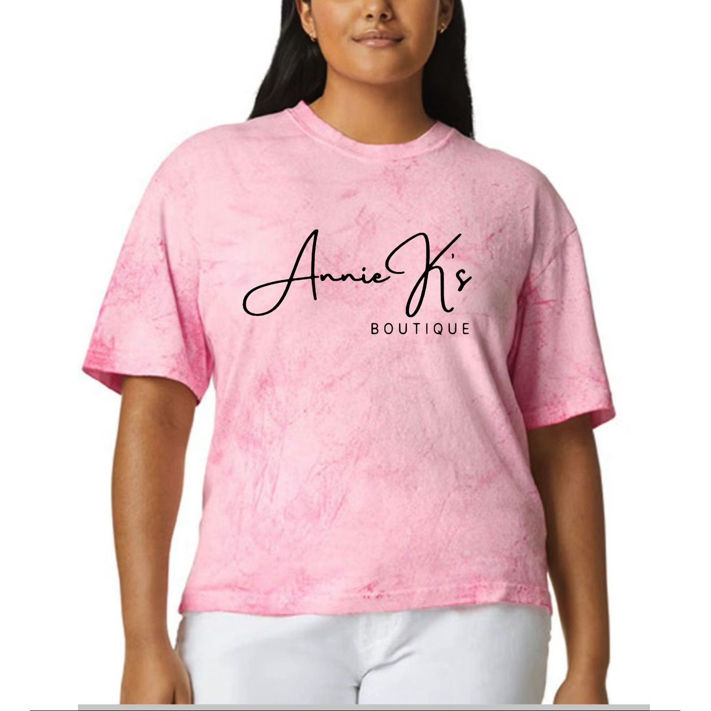 Person wearing a pink t-shirt with 'Annie K's Boutique' text on a white background