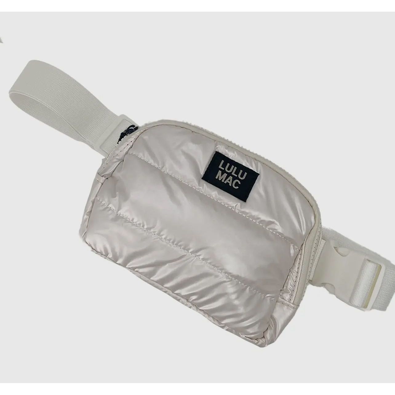 Silver fanny pack with 'LULU MAC' branding on a light gray background