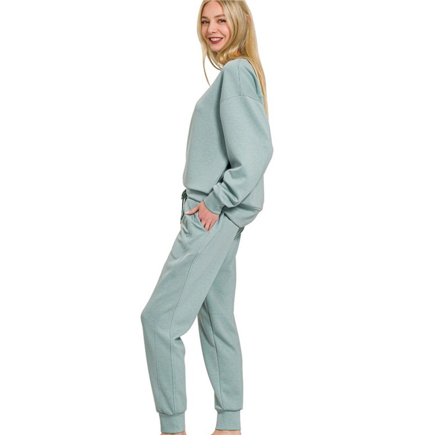 Woman wearing a light blue tracksuit on a white background