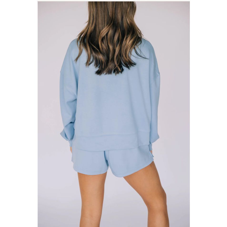 Light blue pajama set worn by a person on a plain background