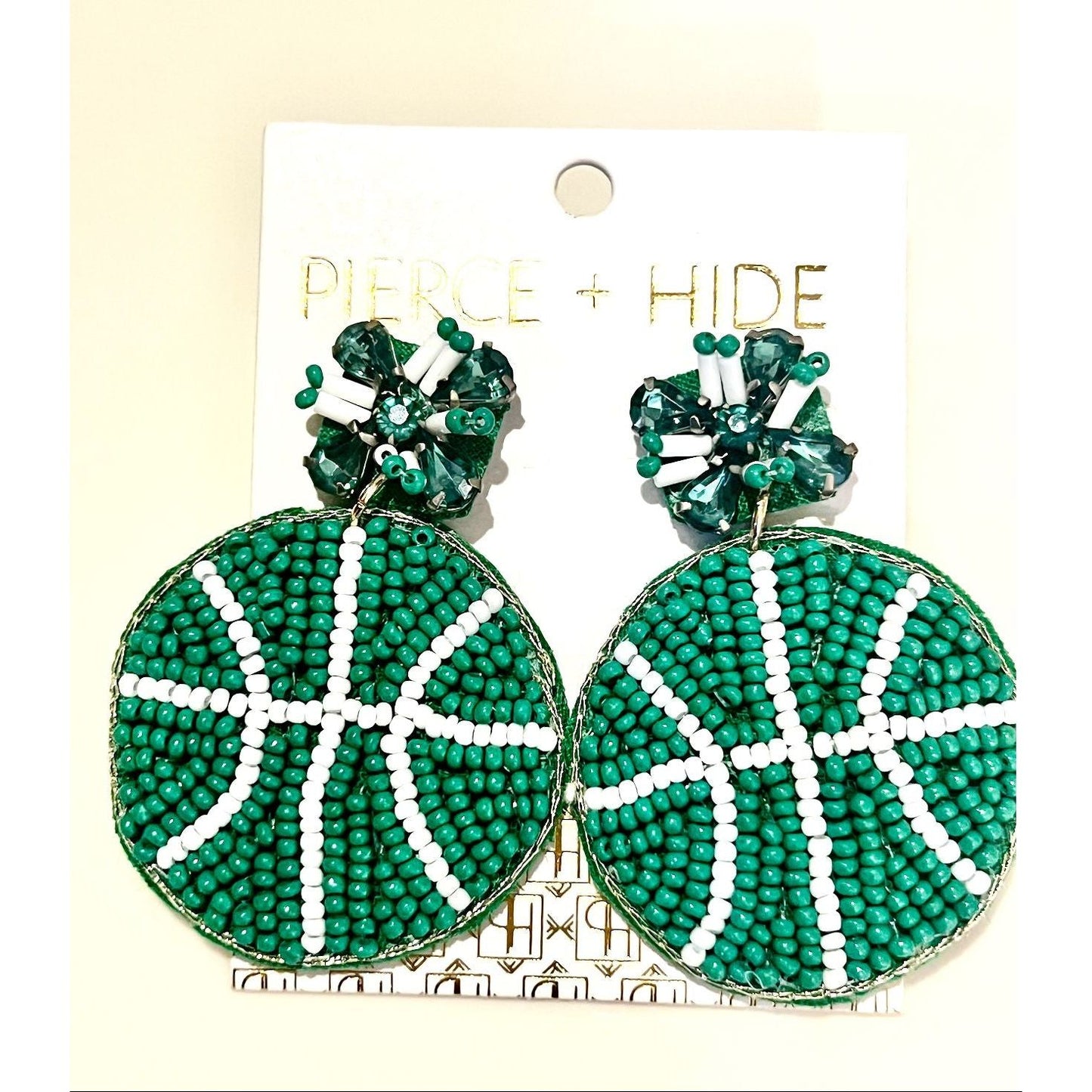 Green beaded earrings on a 'Pierce + Hide' card