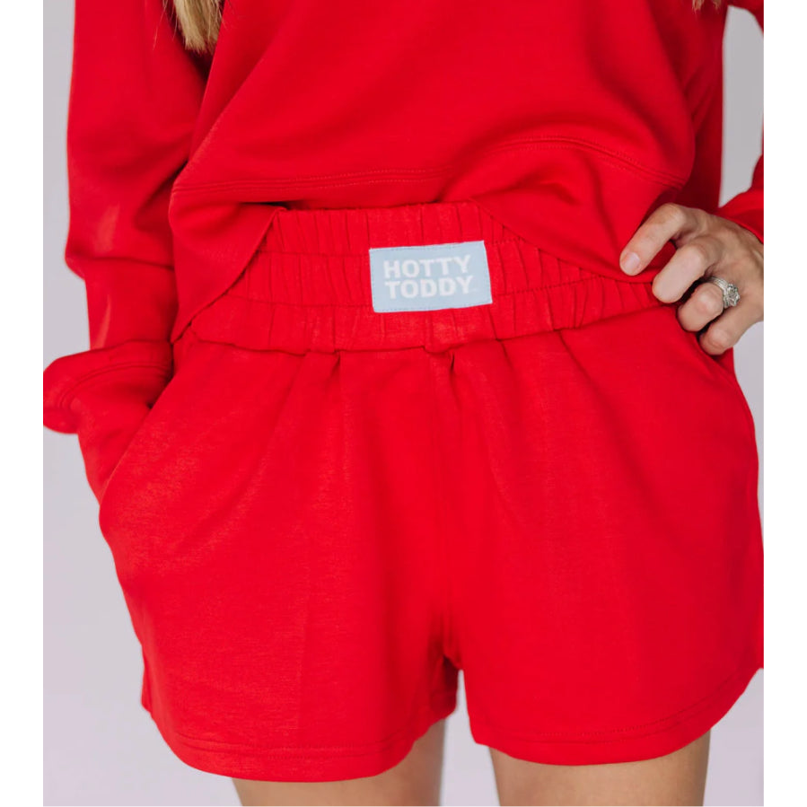 Red shorts with a visible brand label on a plain background
