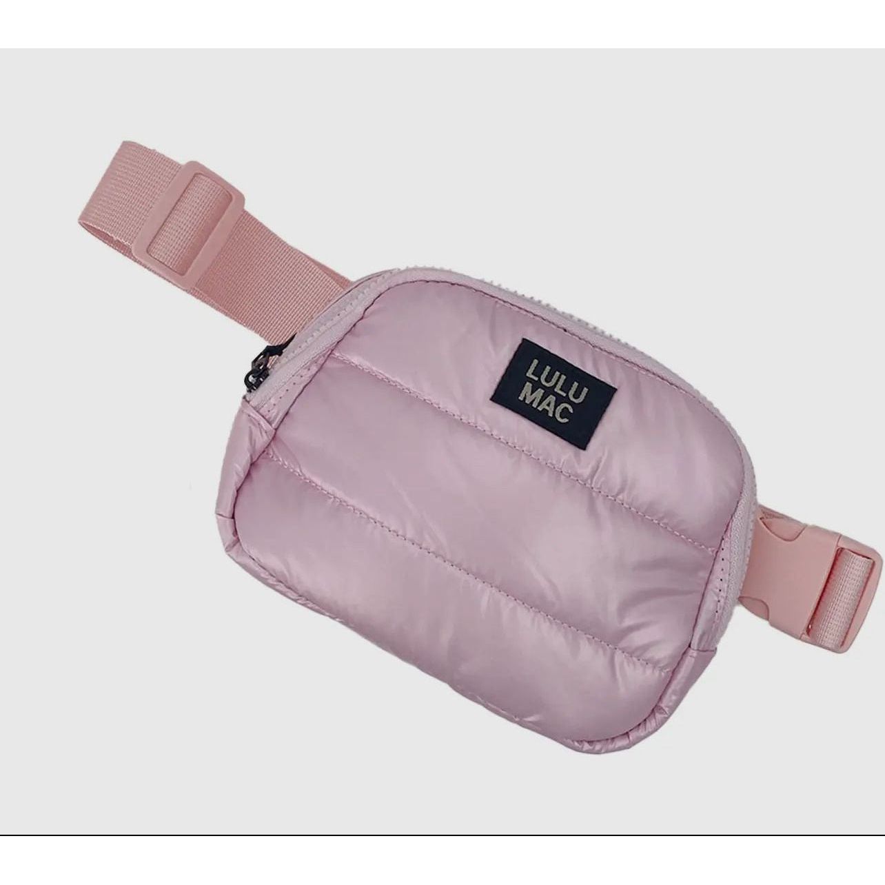 Pink waist bag with a visible brand label on a light gray background
