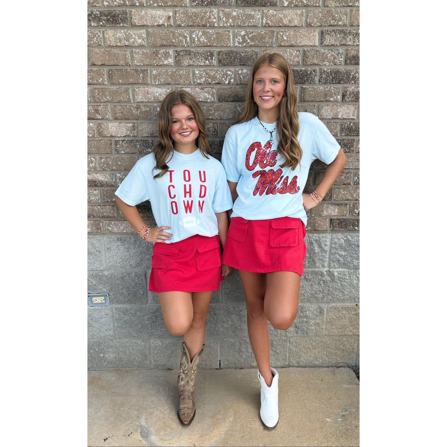 Two women wearing matching outfits with 'Ole Miss' and 'You Had It Wrong' text in front of a brick wall.