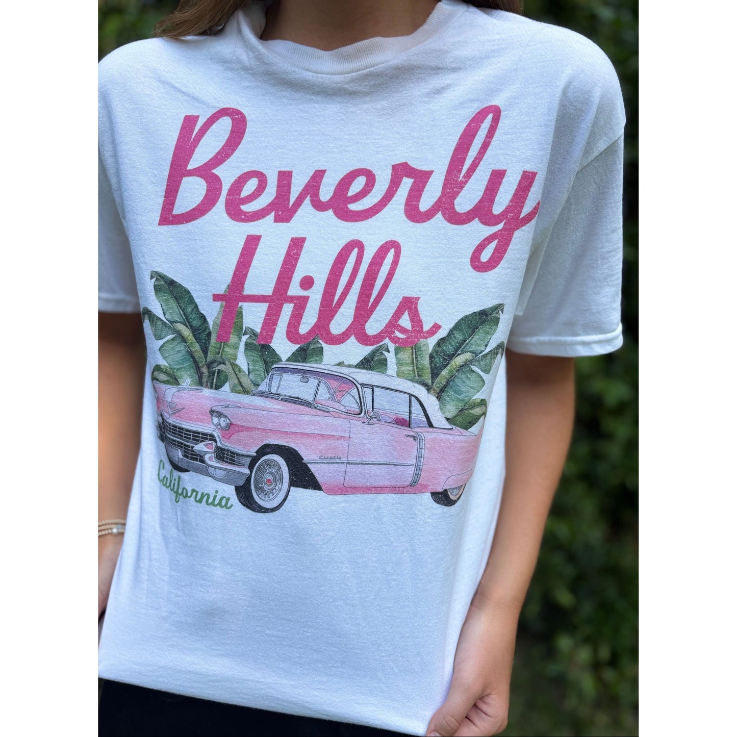White t-shirt with 'Beverly Hills California' graphic featuring a pink car and palm trees.