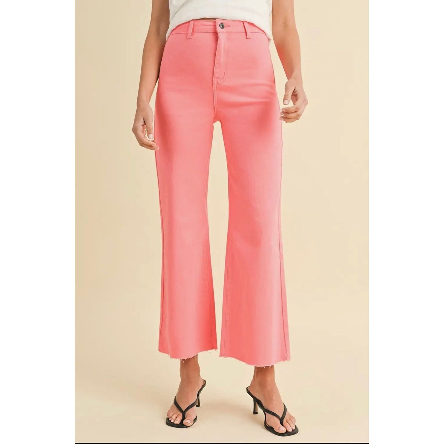 Person wearing pink pants on a beige background