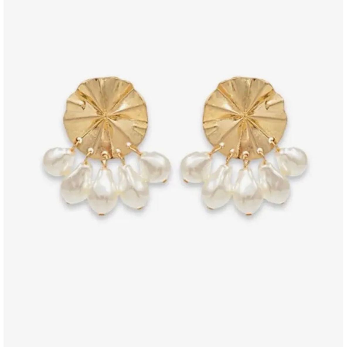 Gold earrings with pearl drops on a white background