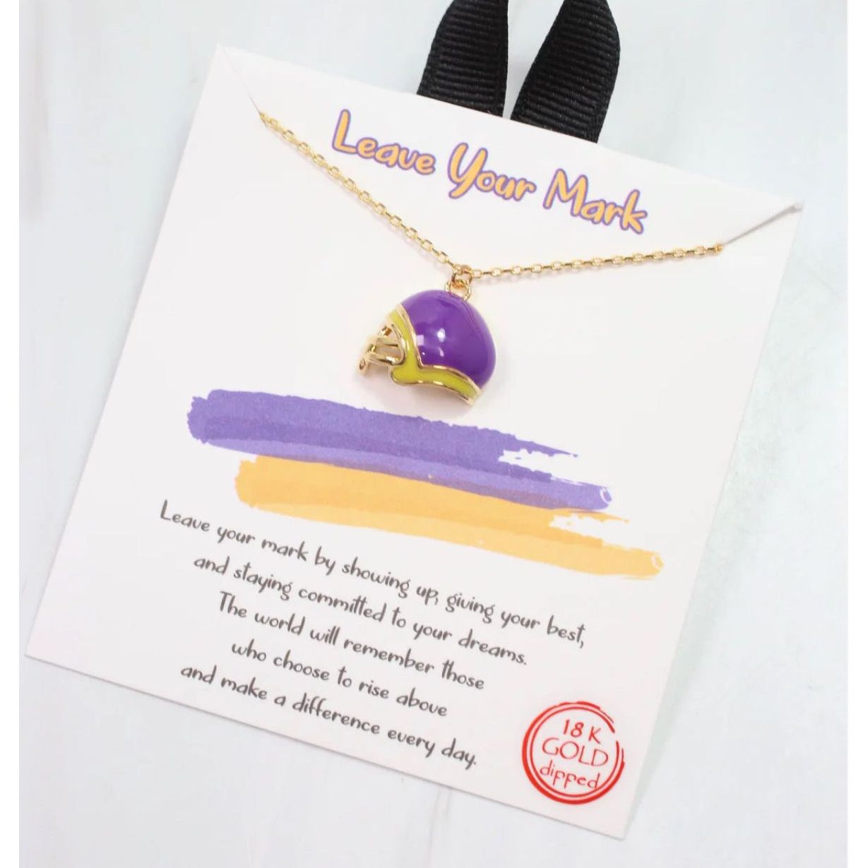 Necklace with purple pendant on a card with text and gold stamp, on a white background