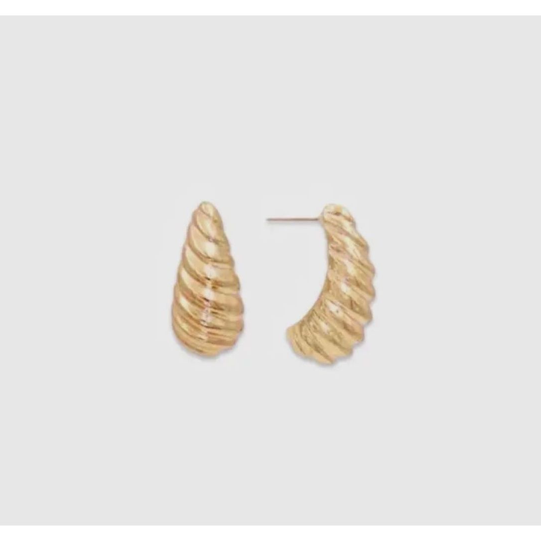 Gold hoop earrings on a light gray background