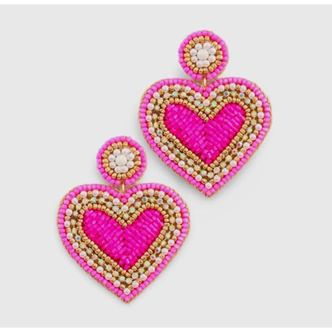 Heart-shaped earrings with pink, gold, and white beads on a light gray background