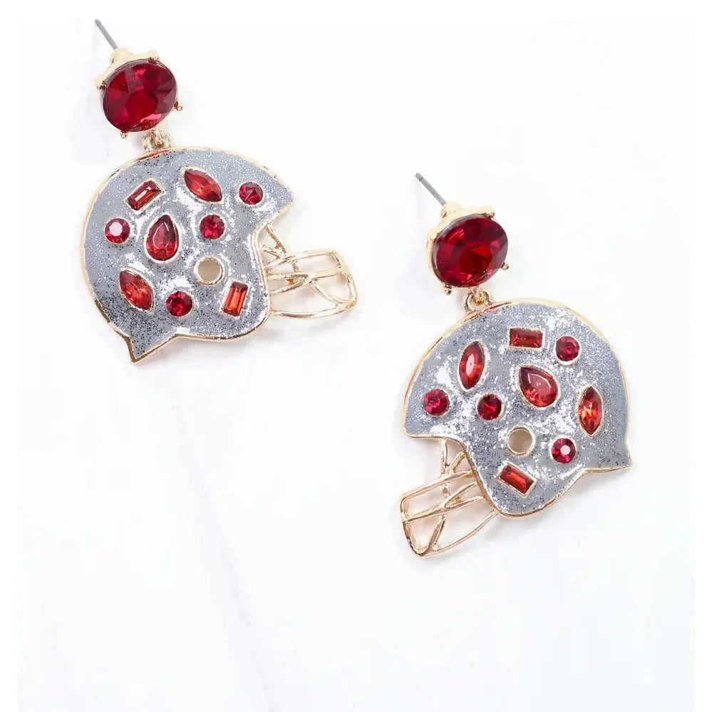 Pair of earrings with red gemstones on a white background