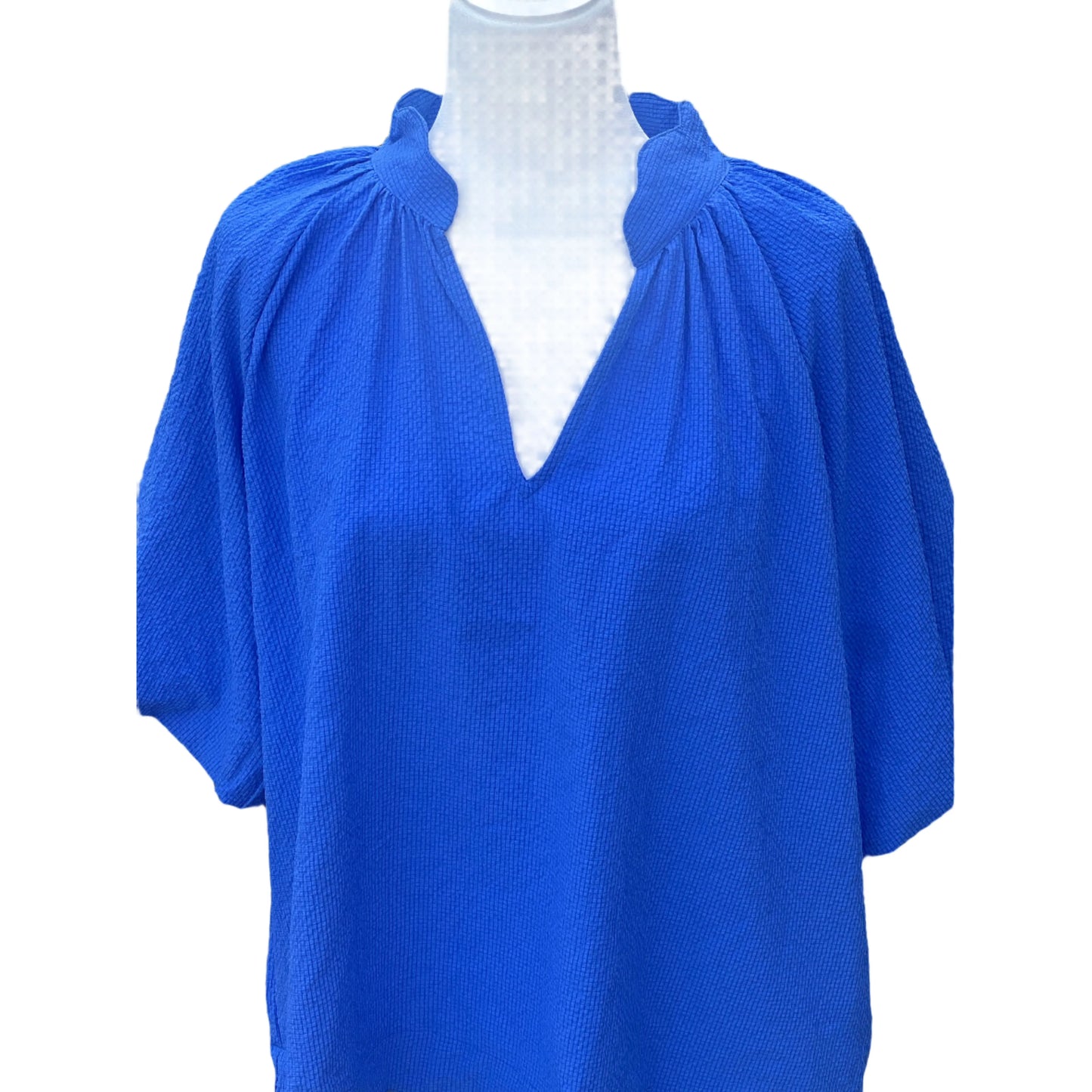 Blue blouse on a mannequin with a white background