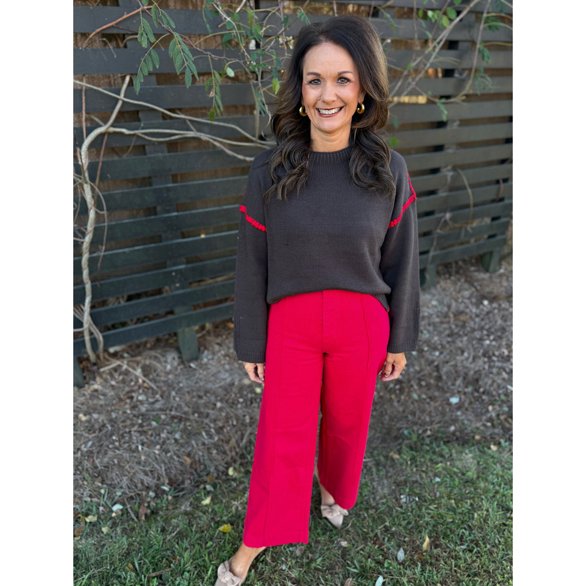 Annie Ks Boutique high-waisted wide-leg ankle pants in Cornell Red stretch cotton worn with a dark brown sweater.