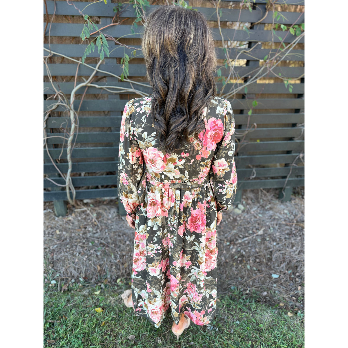 Annie Ks Boutique forest green floral maxi dress with long sleeves and a flowing silhouette, back view