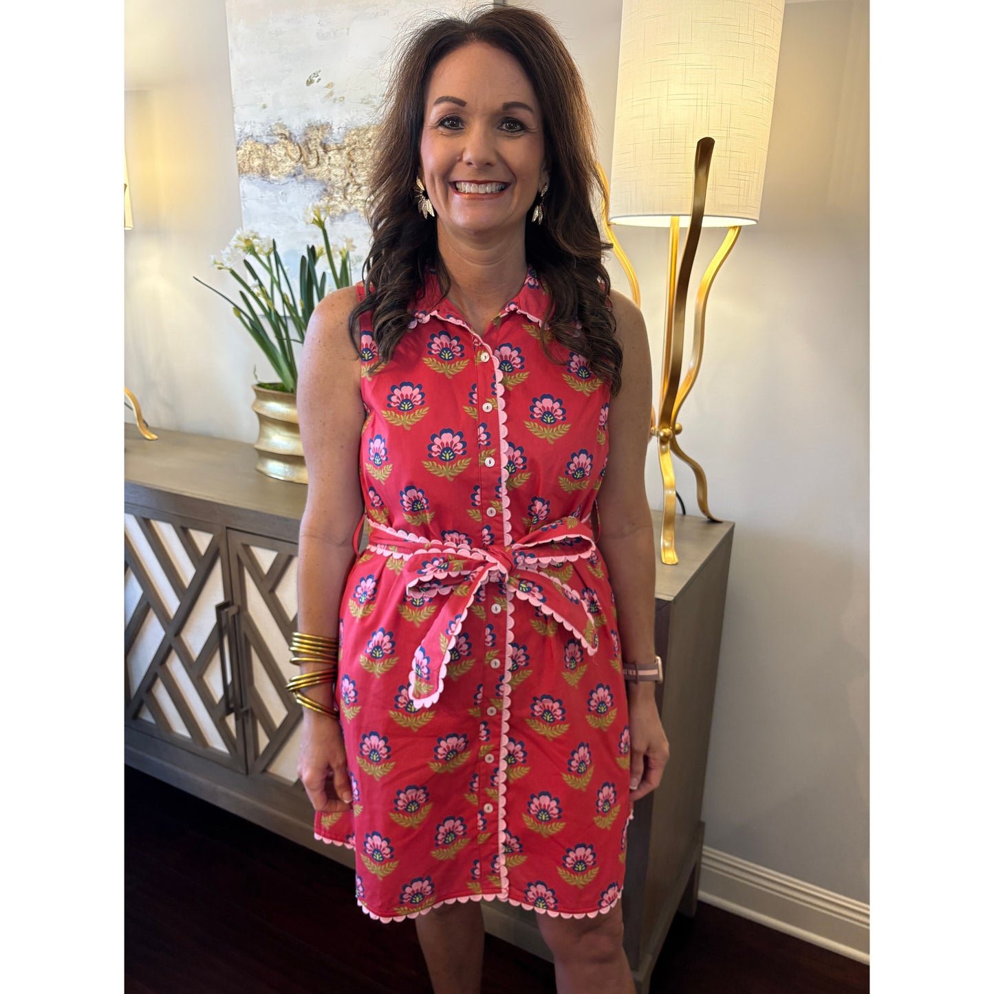 Woman wearing a red floral dress in an indoor setting