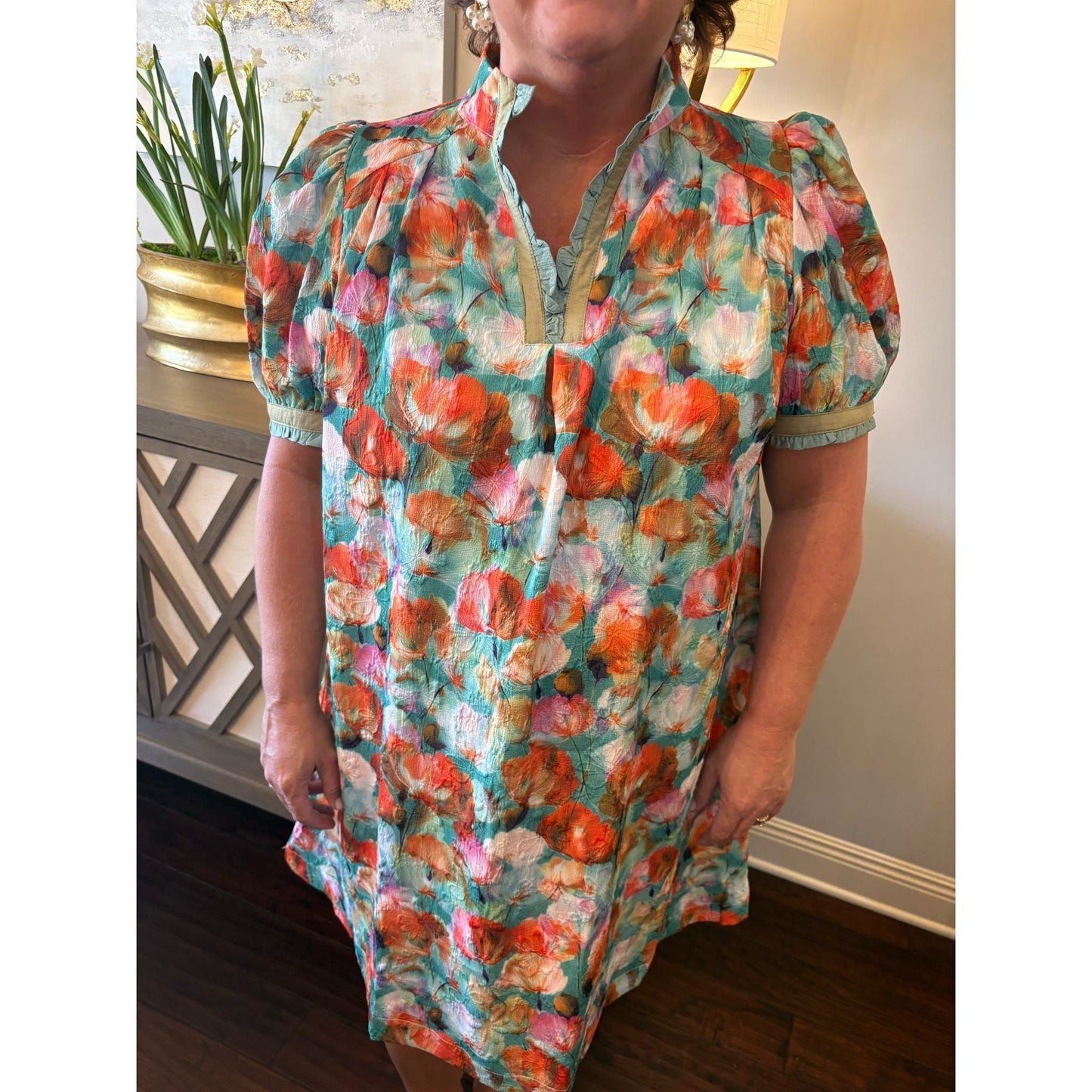 Person wearing a floral dress with a blurred background