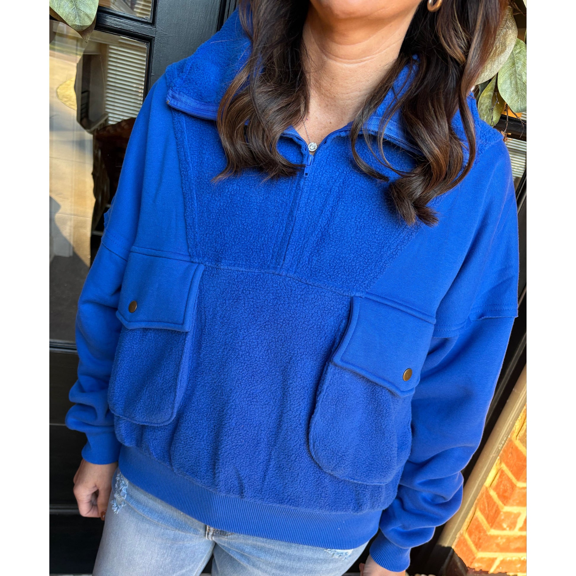 Person wearing a blue jacket with a blurred background