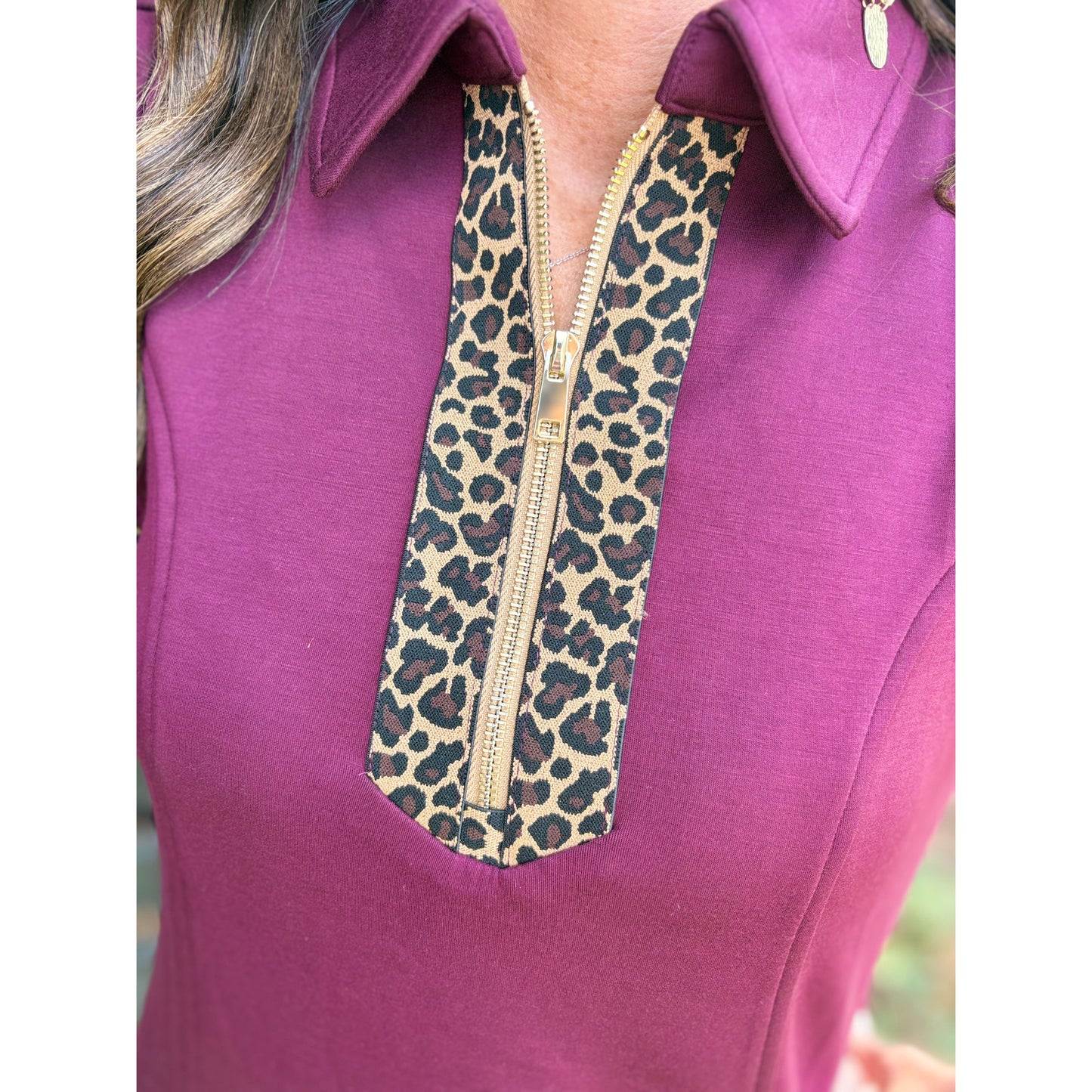 Close-up of a purple garment with a leopard print zipper
