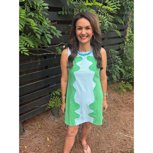 Person holding a green and white towel outdoors