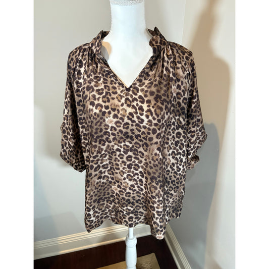 Leopard print fabric on a mannequin with a neutral background