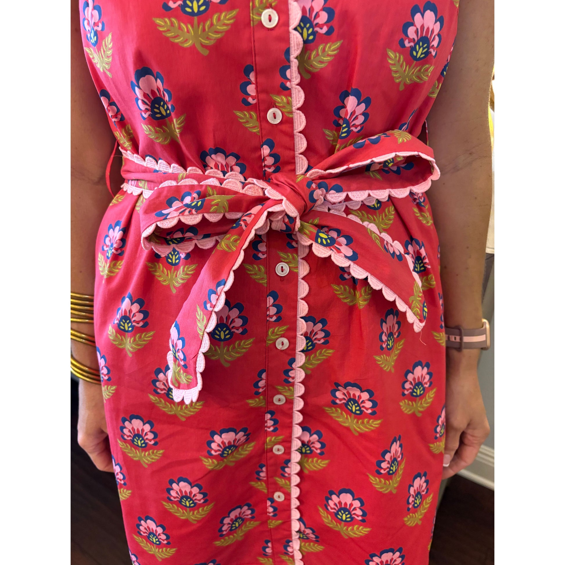 Red floral dress with a close-up of the neckline and buttons.
