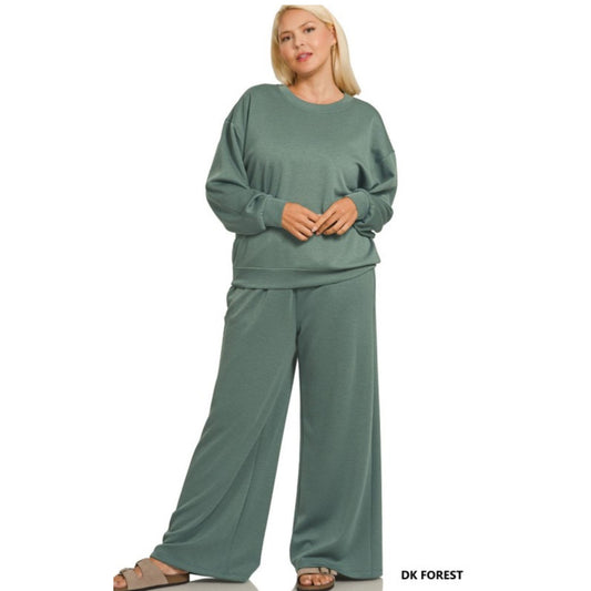 Woman wearing a green lounge set on a white background