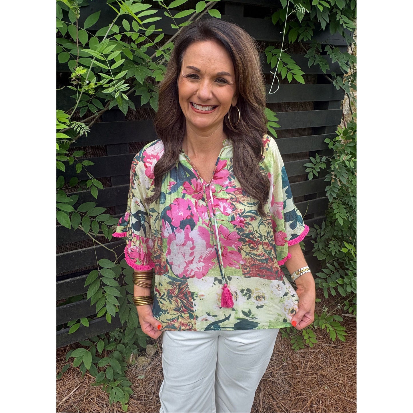 Woman holding a floral-patterned bag outdoors