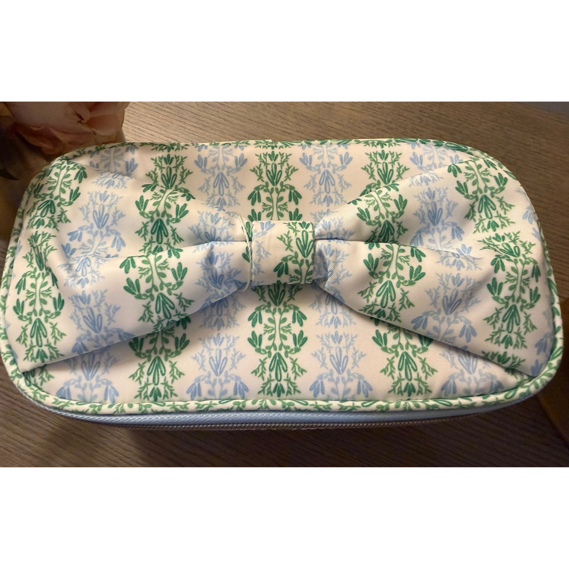 Folded fabric with green and blue pattern on a wooden surface