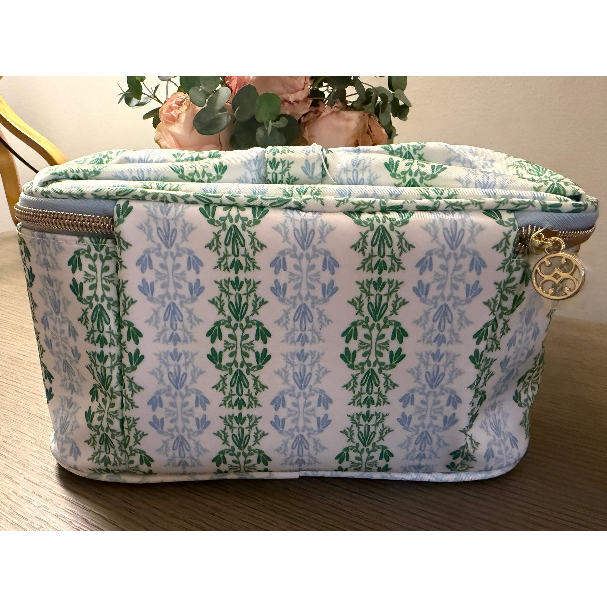 Patterned fabric pouch with floral design on a wooden surface