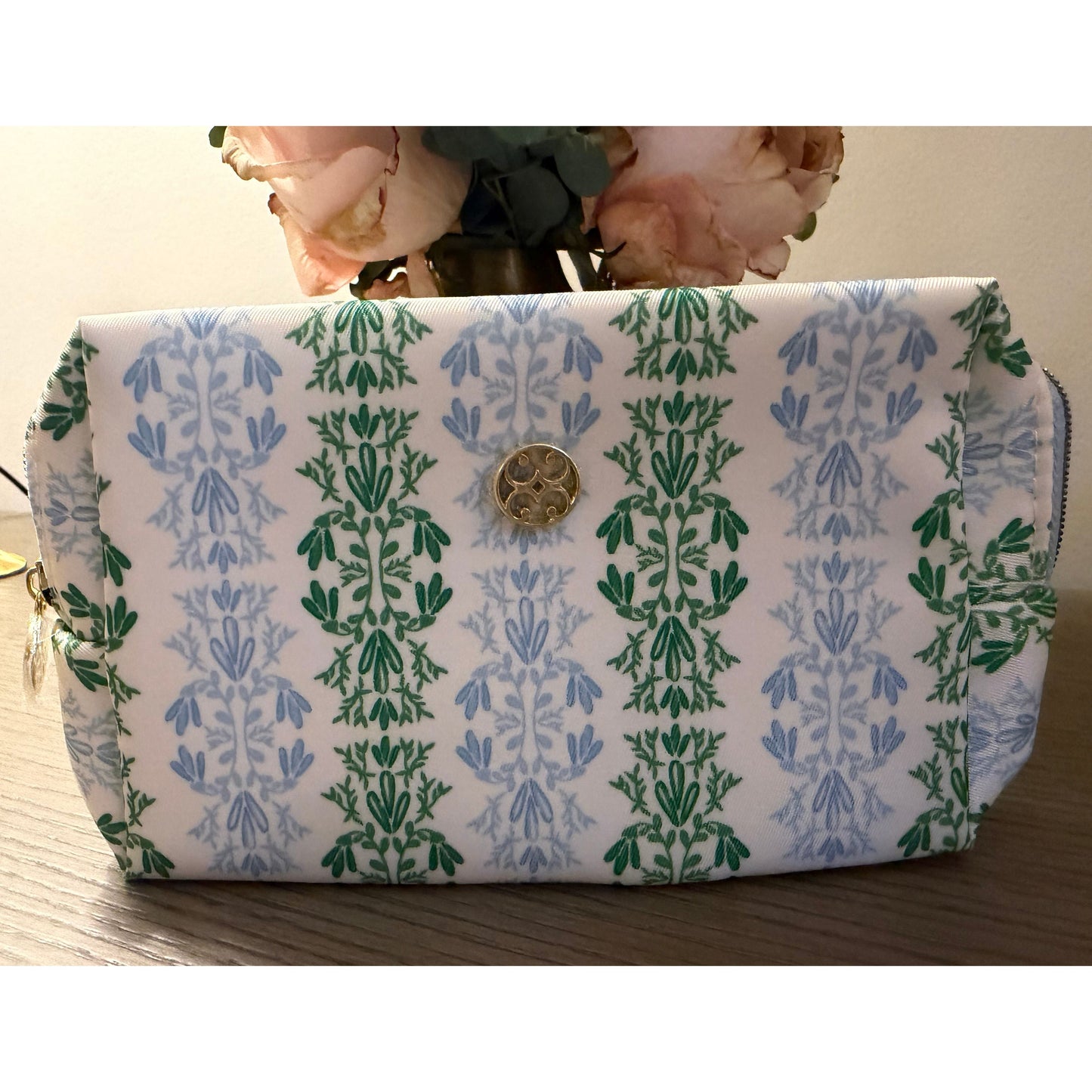 Small cosmetic bag on wood surface.