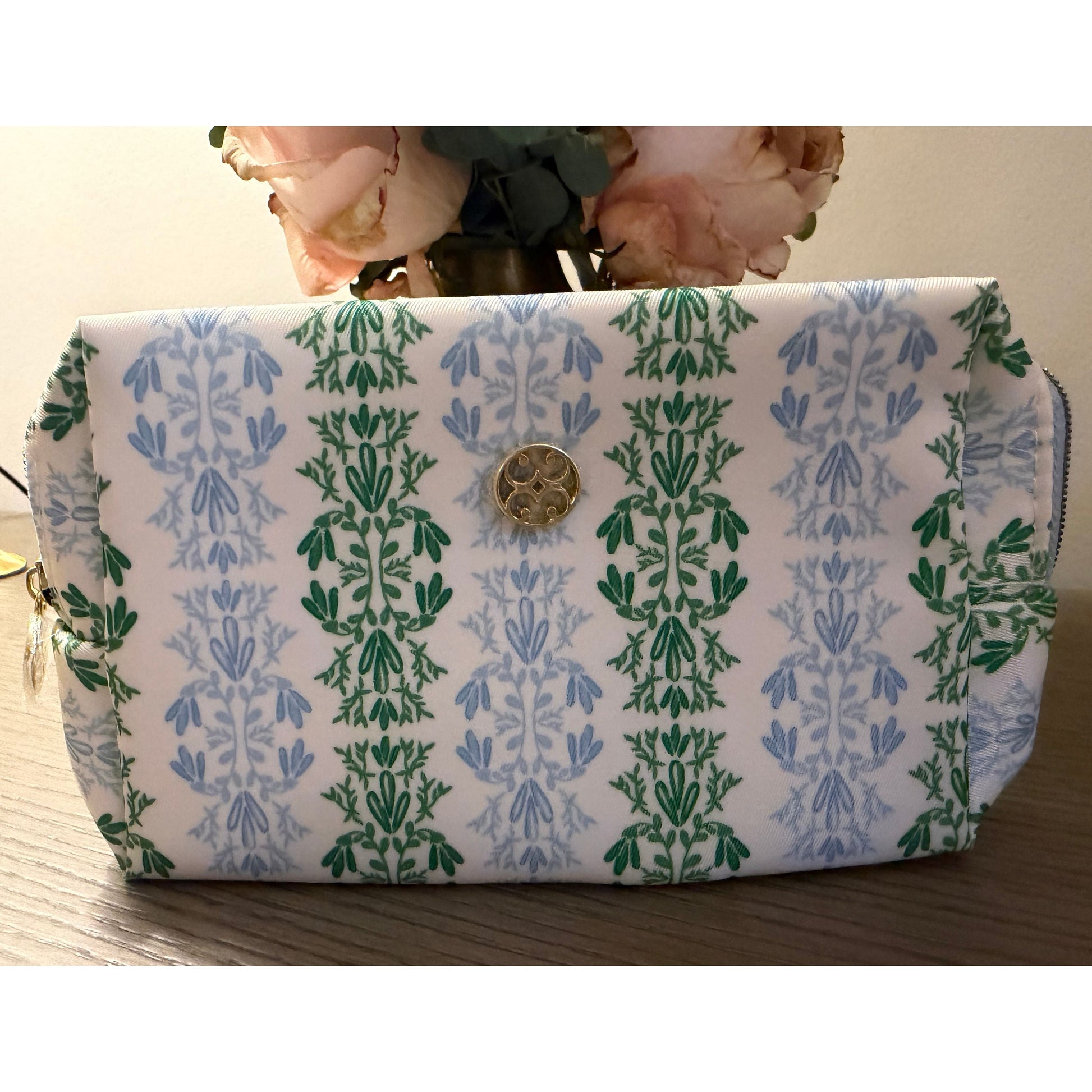 Small cosmetic bag on wood surface.