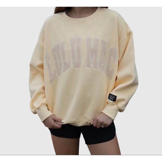 Beige sweatshirt with text and logo on a plain background