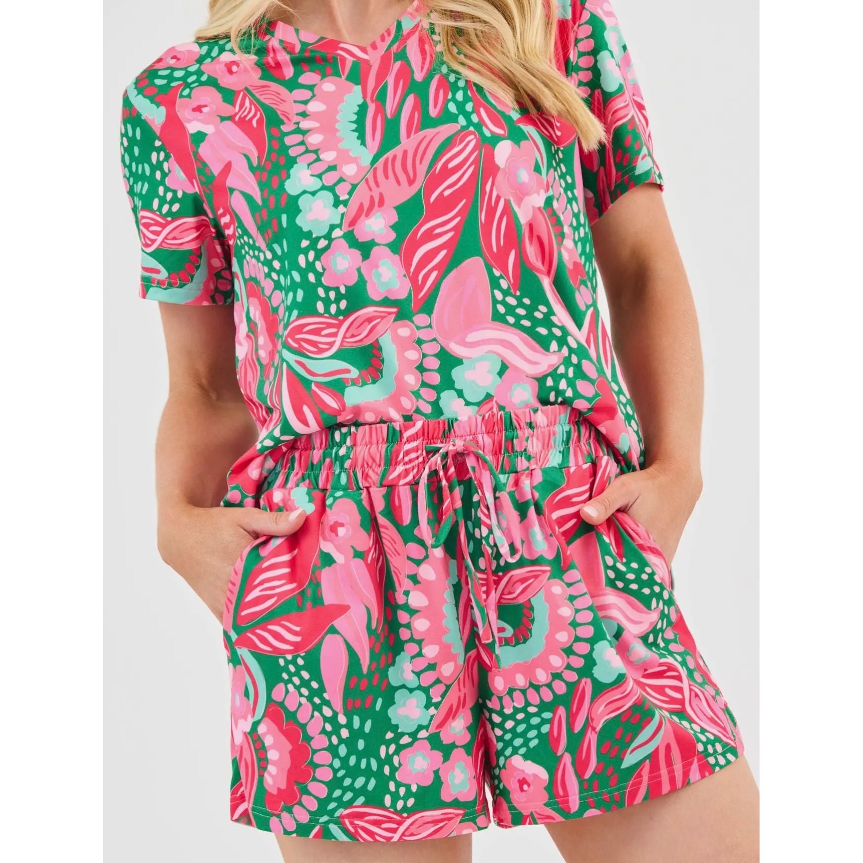 Woman wearing a colorful patterned romper on a white background