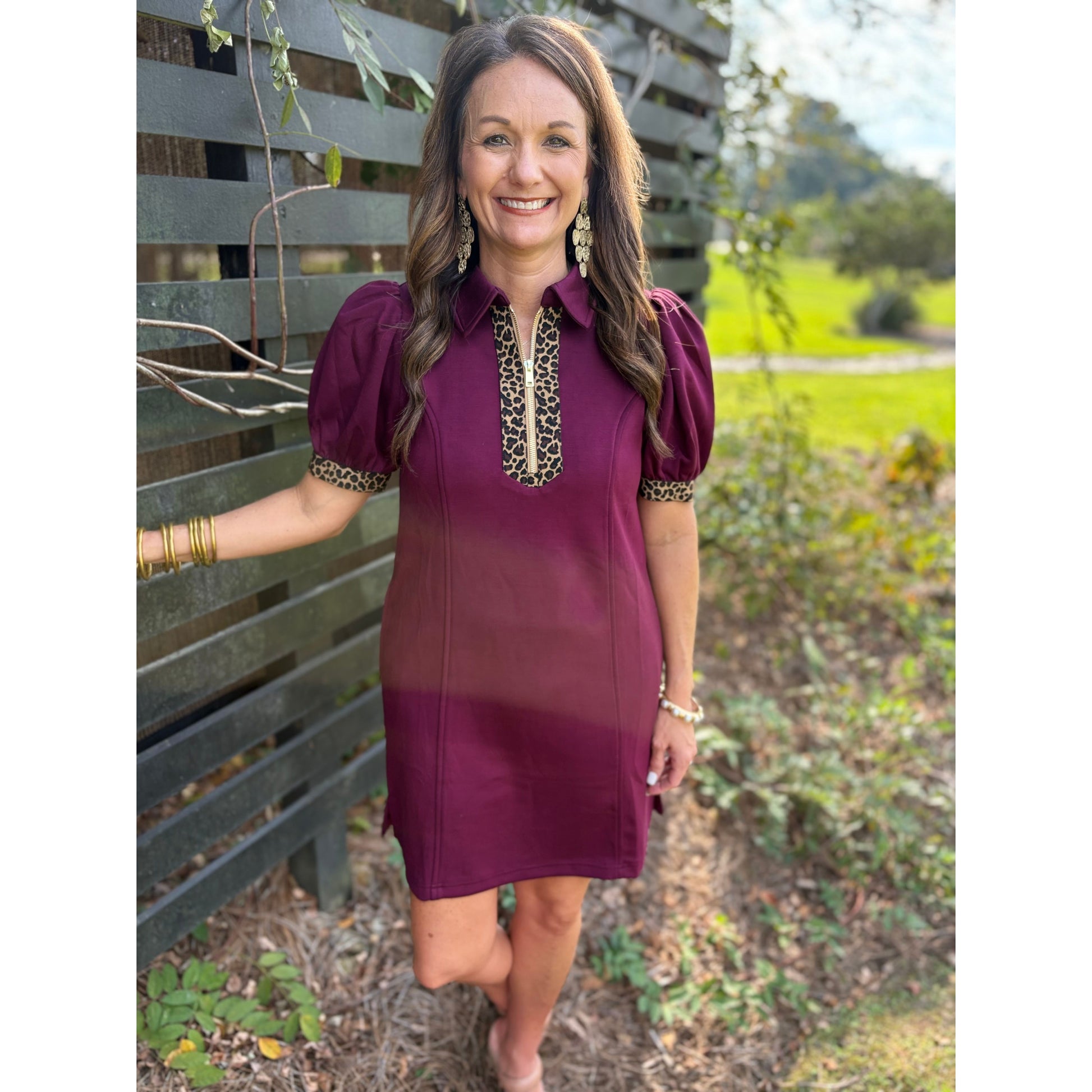 Woman wearing a burgundy dress with decorative elements outdoors