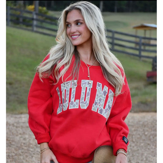 Woman wearing a red sweatshirt with 'LULUMAC.