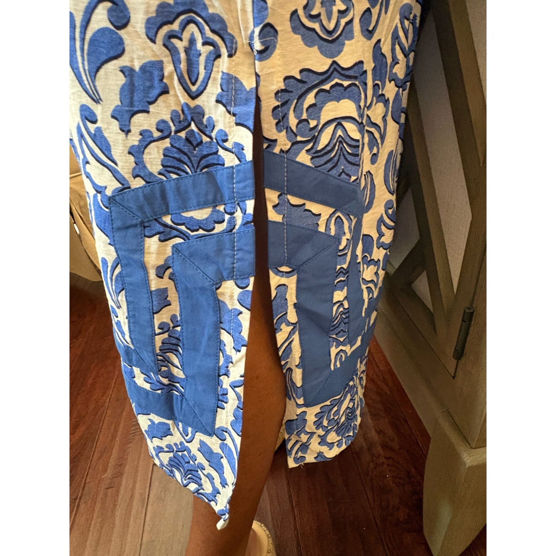 Blue and yellow patterned pants on a wooden floor