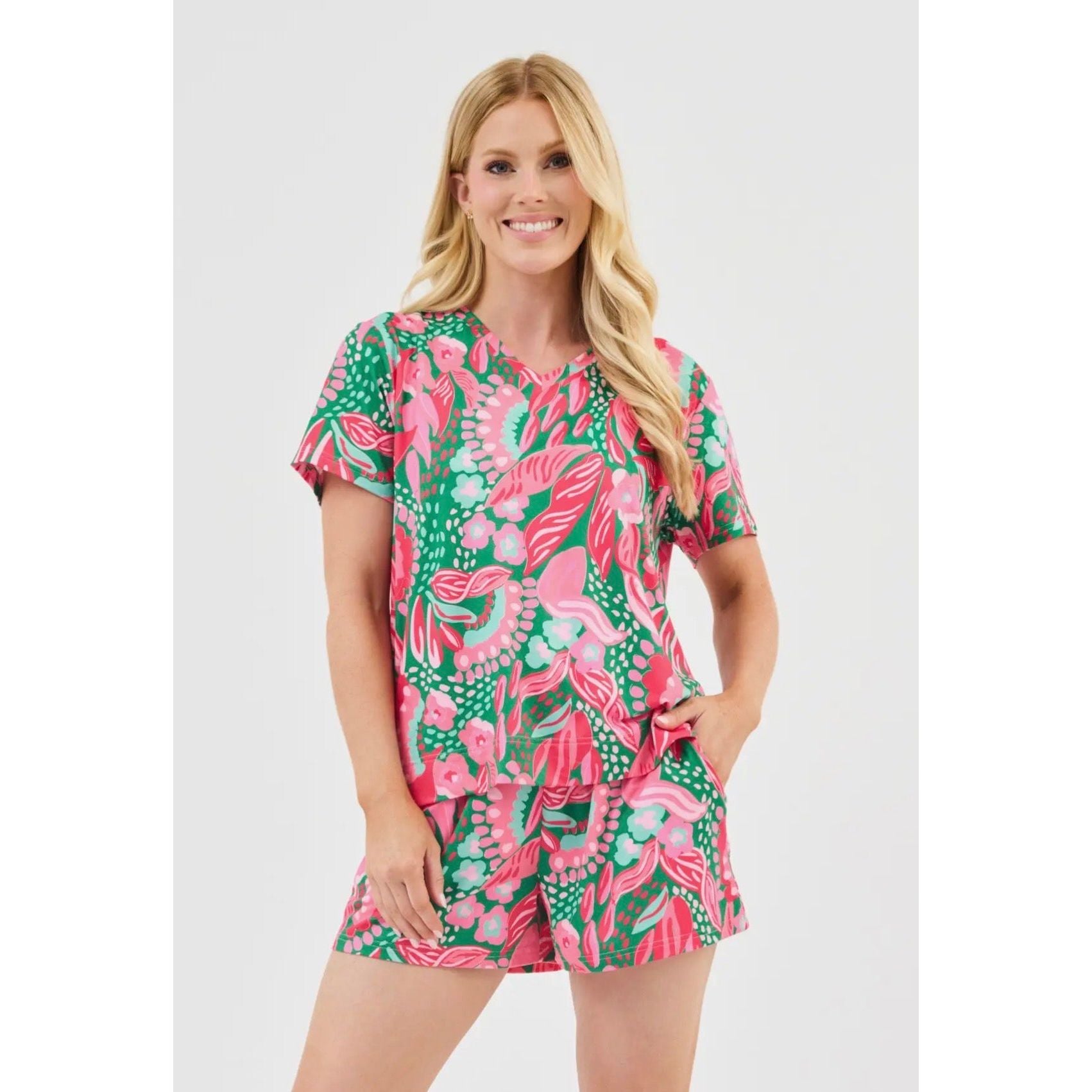 Woman wearing a colorful floral dress on a white background
