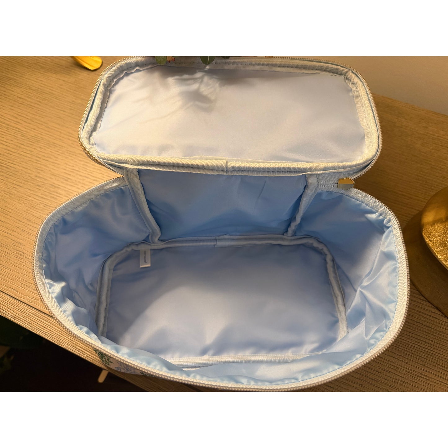 Light blue insulated bag on a wooden surface