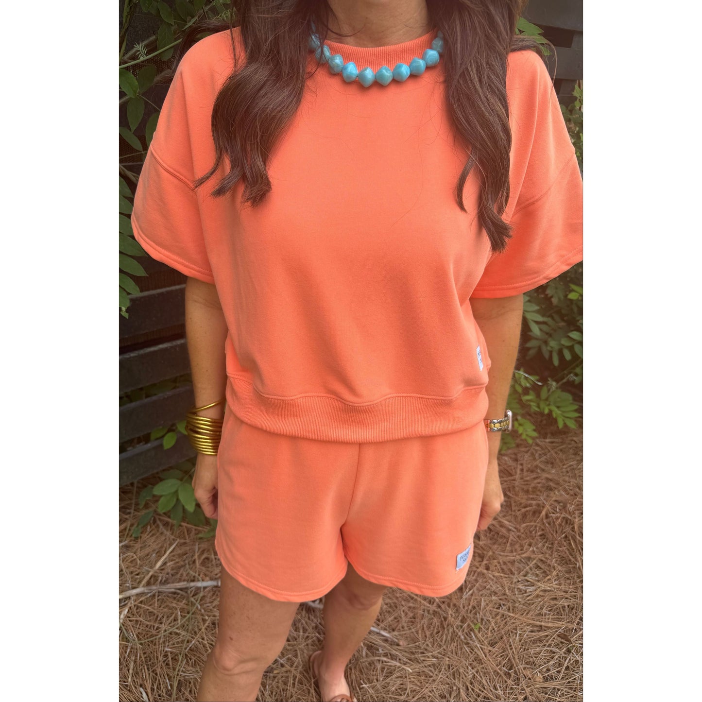 Person wearing an orange sweatshirt with a blurred background
