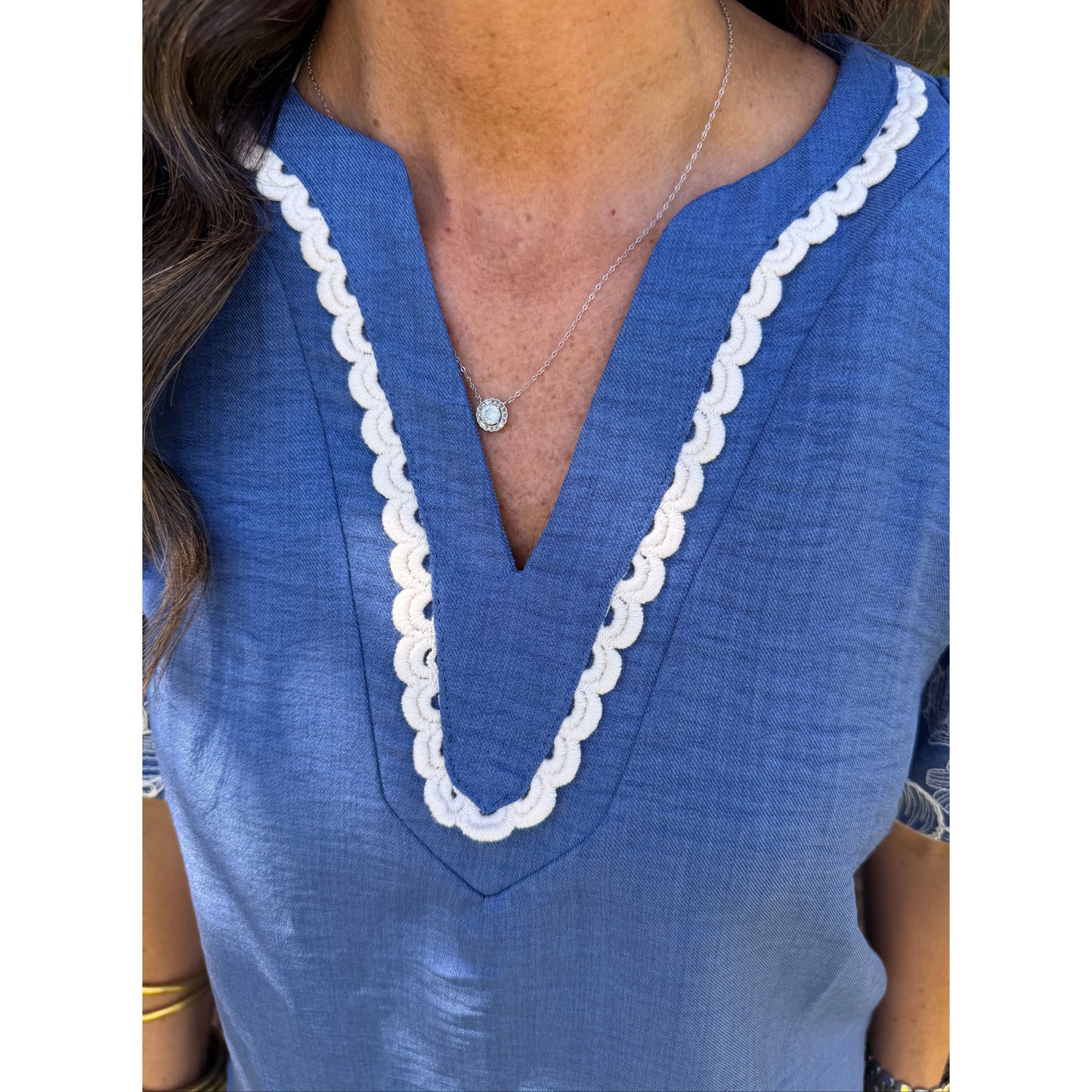 Close-up of a blue garment with white trim