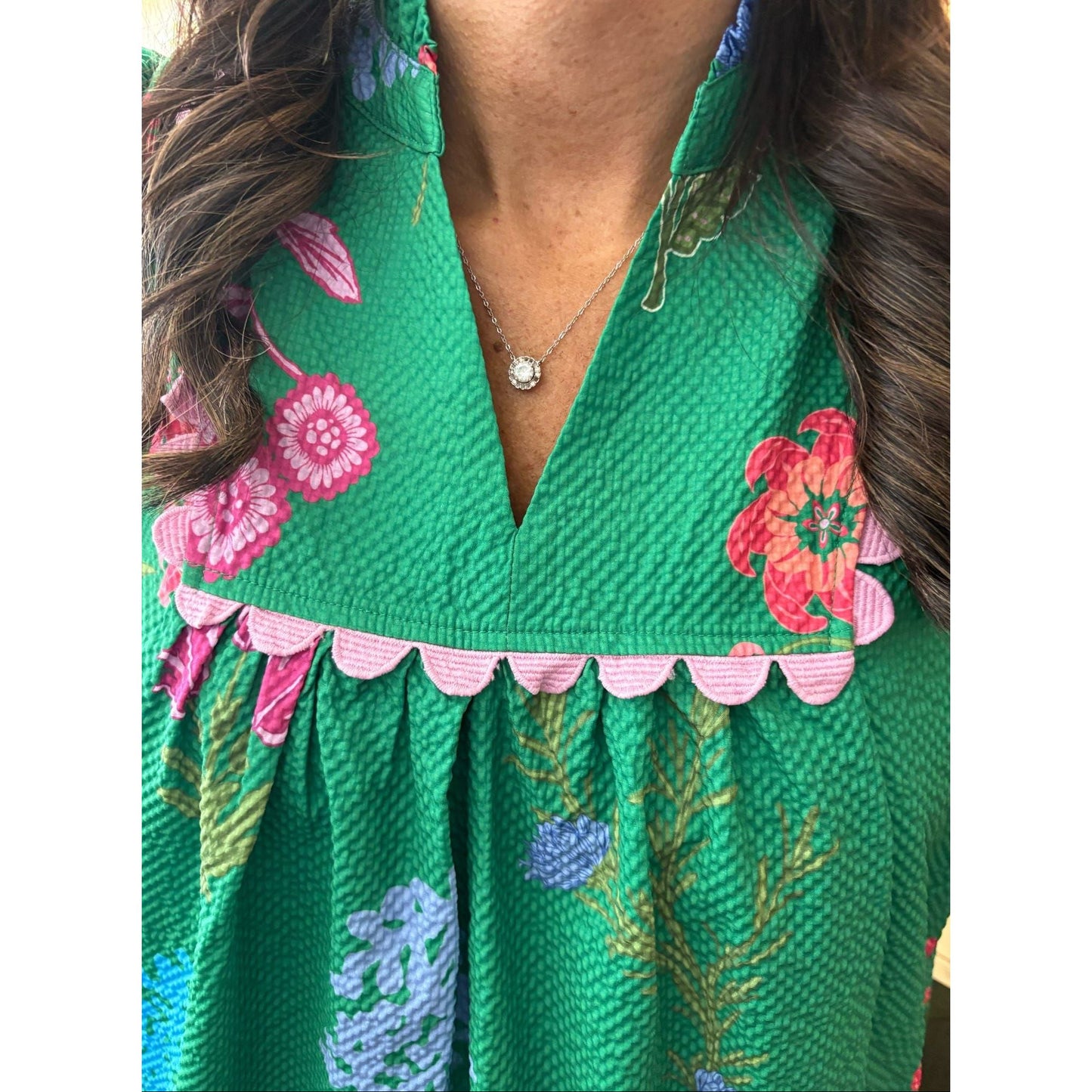 Green floral dress with pink and blue accents