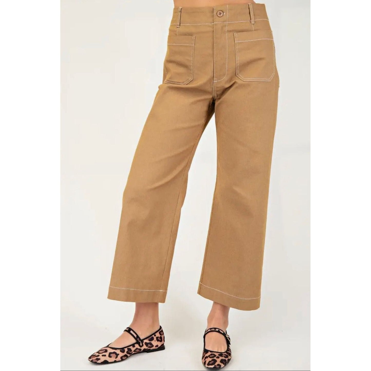 Tan pants worn by a person on a white background