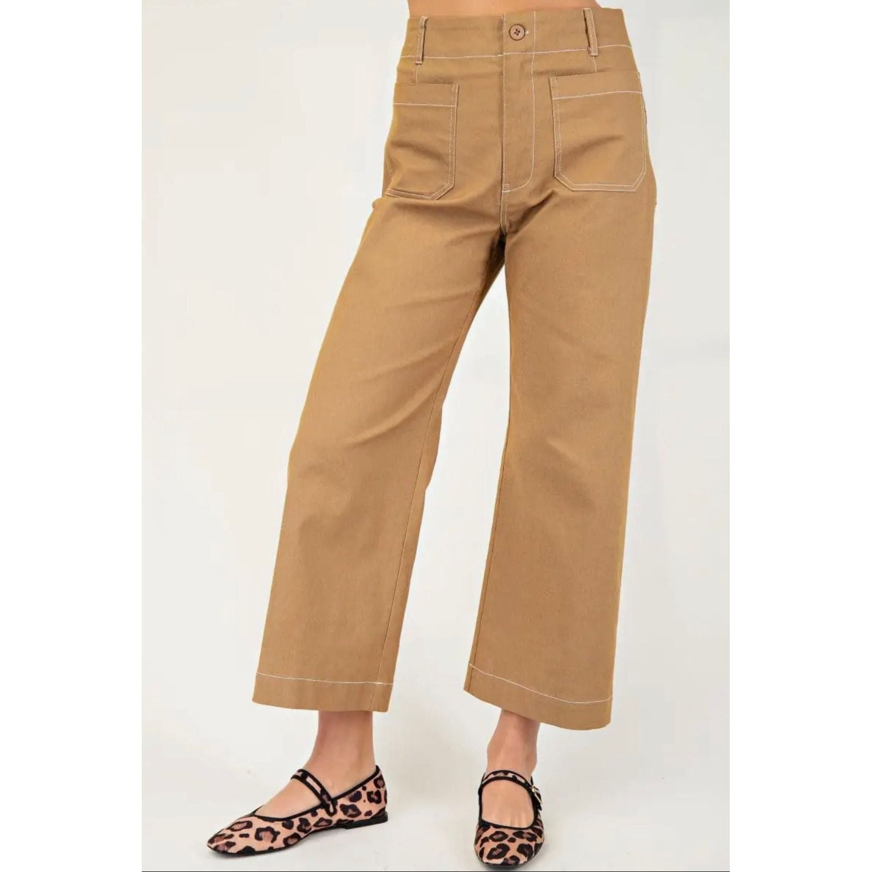 Tan pants worn by a person on a white background