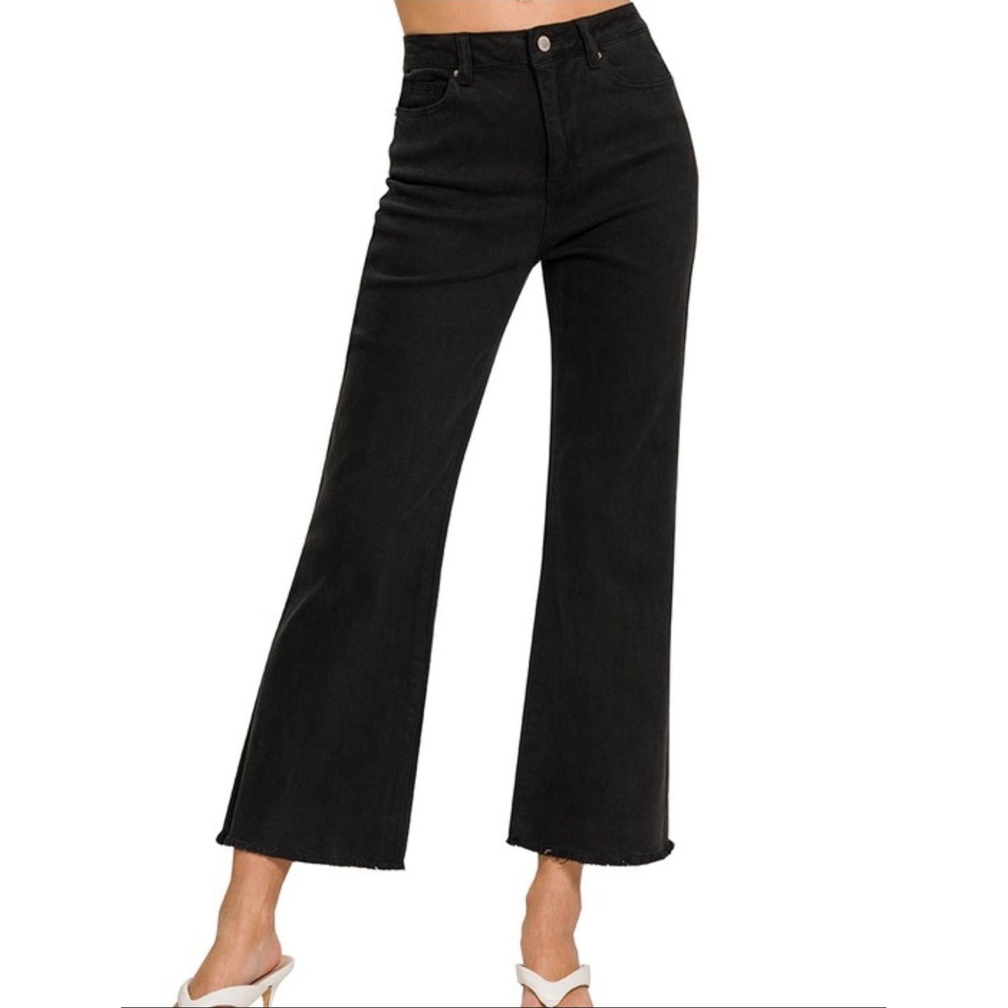 Black jeans worn by a person on a white background