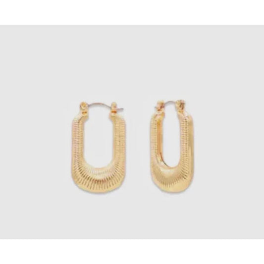 Gold hoop earrings on a light gray background