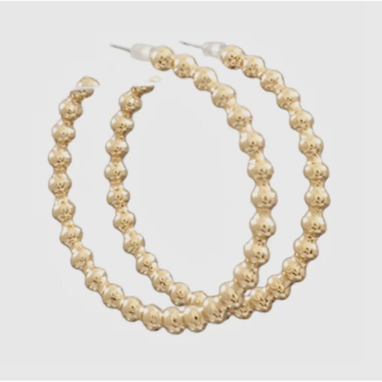 Pair of gold hoop earrings on a white background