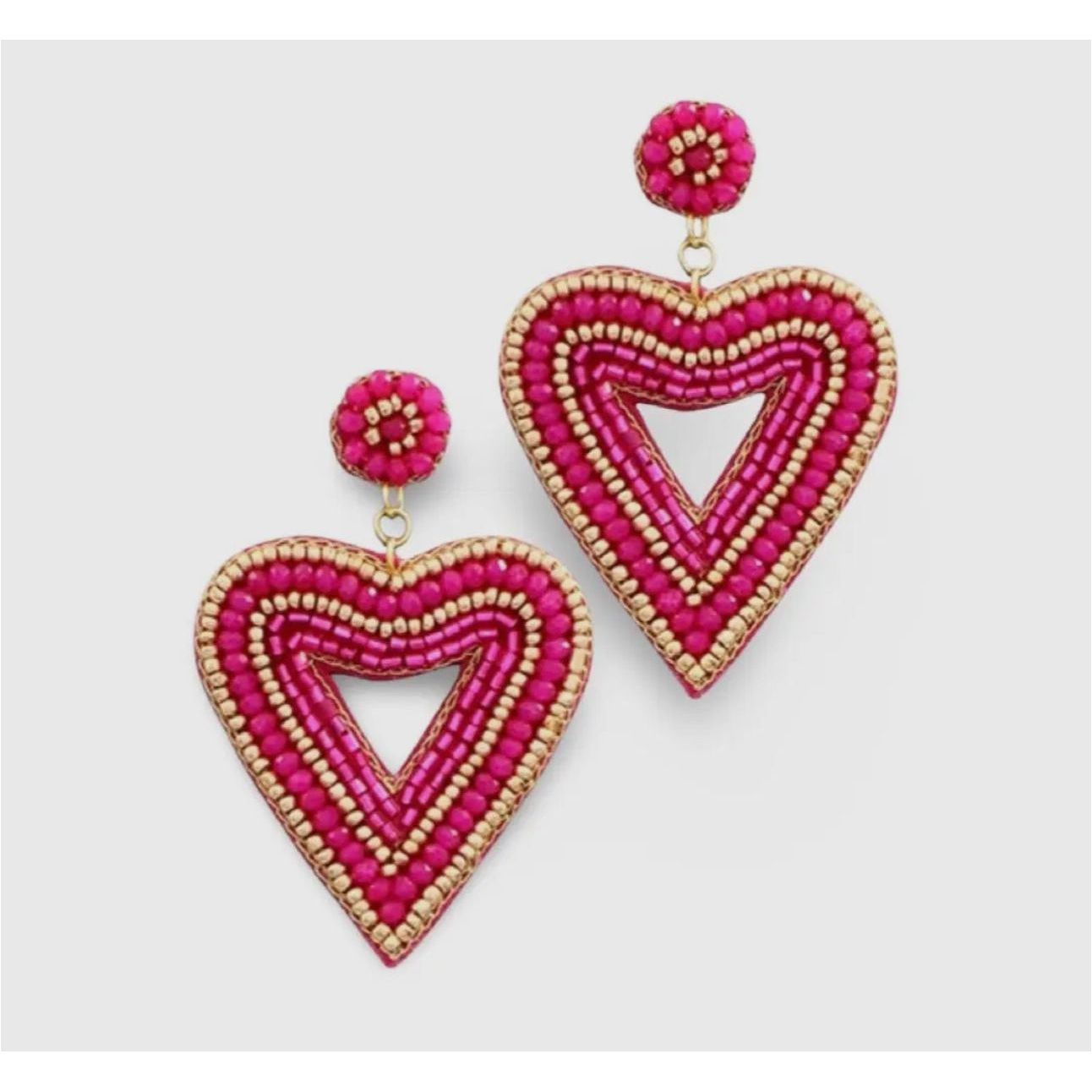 Heart-shaped beaded earrings with pink and gold details on a light gray background
