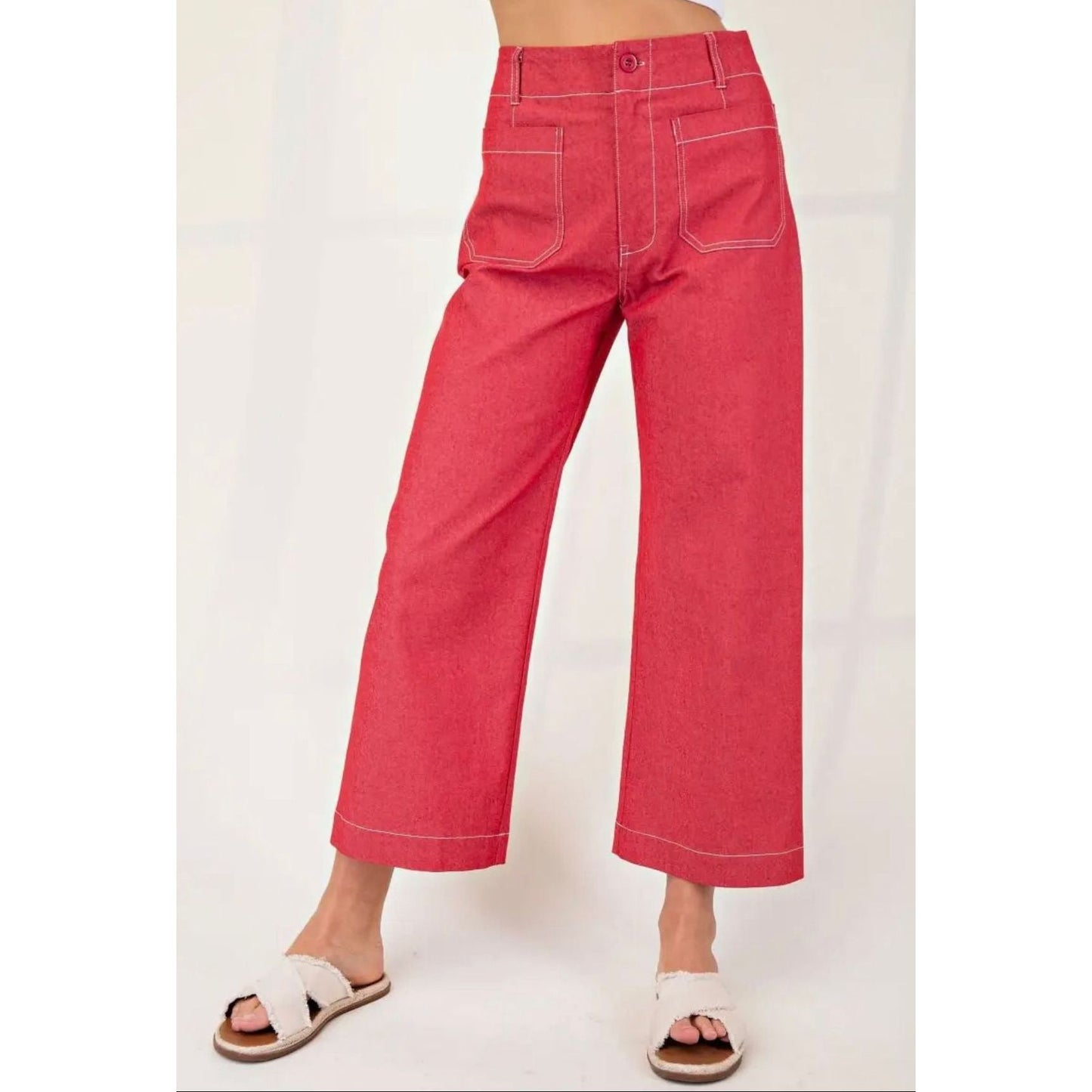 Red wide-leg pants worn by a person on a white background