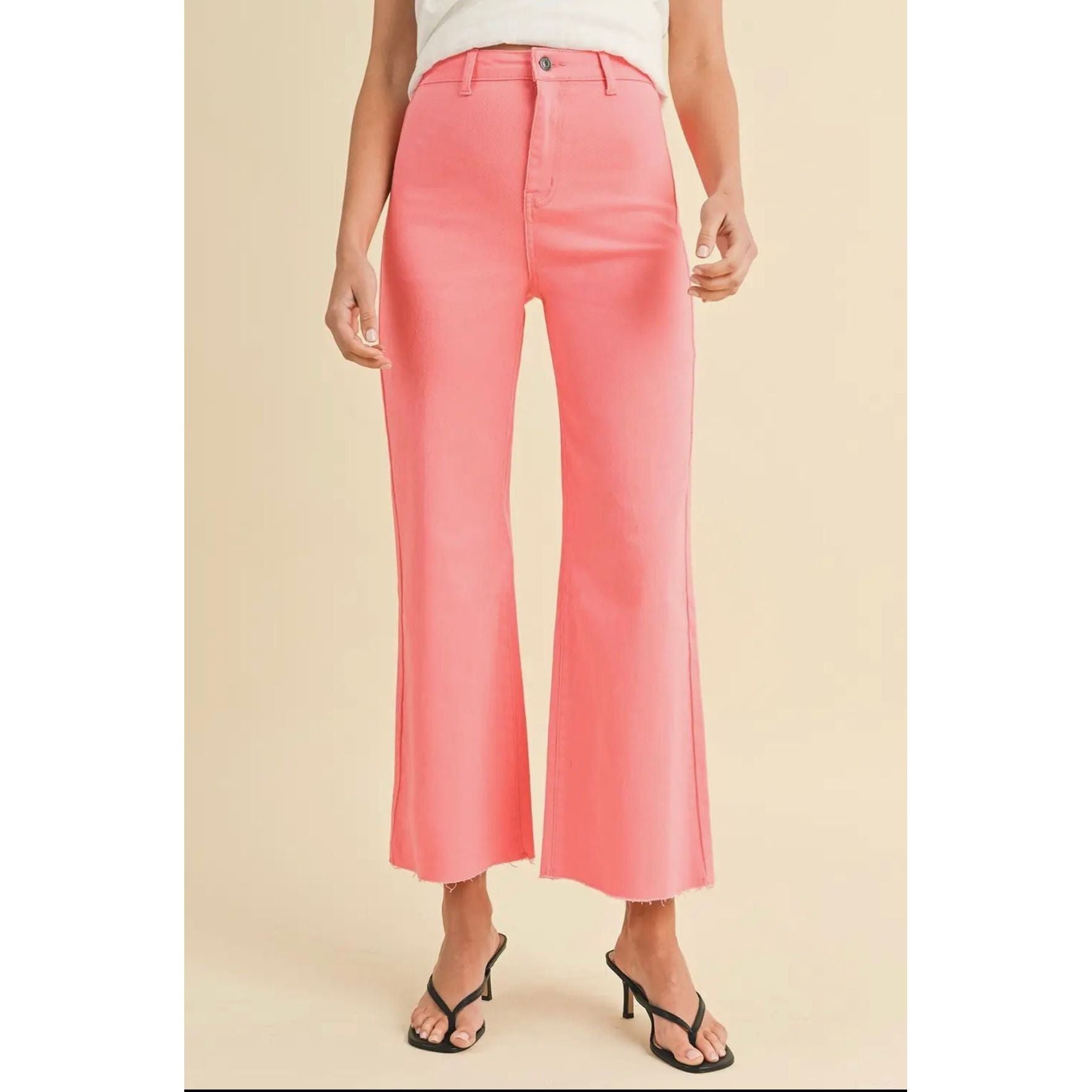 Person wearing pink pants on a beige background